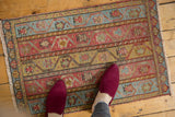 Distressed Turkish Oushak rug showcasing alternating meandering vine motifs with time-softened tones.