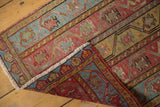 Distressed Oushak rug corner with fringe, reverse, and worn saffron, powder blue pile.