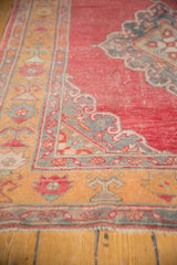 Distressed Oushak runner with cherry red field, saffron border, and grey scalloped Rococo motif.