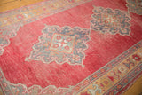 Distressed cherry red field with scalloped Rococo-inspired medallions and plant motif border.