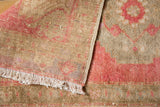 Faded low pile texture and woven foundation of vintage distressed Oushak rug.