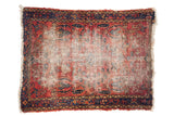 Vintage Persian Lilihan square rug, worn cherry red field, faded floral motifs, navy border.