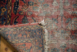 Vintage Lilihan rug's hand-knotted foundation, tattered fringe, and geometric reverse pattern.