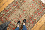 Silver, brick red, charcoal geometric medallions and motifs on the antique Caucasian rug.