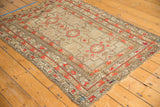 Geometric border and field design on an antique Caucasian rug, showing rust-red patterns and even wear.
