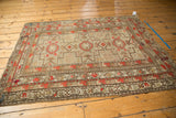 Geometric minor border with a secured edge and visible patch on the antique Caucasian rug.