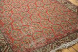 Vintage Hamadan rug with brick red boteh field showing wear, foundation, and corner fringe.