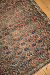 Belouch runner's allover pomegranate field, geometric border, and tattered edge in blush, chocolate, blue.