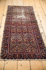 Vintage Persian Yazd runner's gold, wine red, navy floral field, blossomed border, and tattered side.