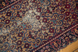 Vintage Yazd rug runner corner, navy border with blossomed buds, tattered edge.