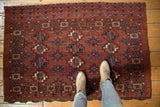 Low pile vintage Chodor Turkmen rug with dynamic gul motifs in chestnut brown and navy.