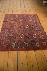 Secure end of the vintage Chodor Turkmen rug, displaying chestnut, navy, and ivory geometric patterns.