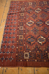 Low pile geometric gul motifs of a vintage Chodor Turkmen rug in chestnut brown and navy.