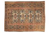 Vintage hand-knotted Caucasian rug, geometric medallions and borders in beige, blues, and blush.