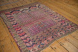 Angled detail of hand-knotted antique Turkmen rug, fuchsia field with tent cover motif.