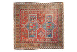 Vintage Caucasian Avar square rug, cherry red field, elongated blue medallions, geometric animal motifs.