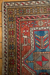 Vintage Caucasian Avar rug corner, geometric borders, cherry red, sky blue patterns, even wear.