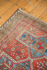 Vintage Caucasian Avar style rug corner with geometric borders, pinwheels, and cherry red, sky blue tones.