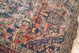 Antique Malayer rug: faded cherry, navy, ivory serrated patterns, visible knot wear, tattered fringe.