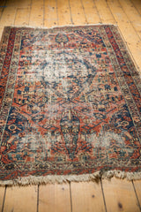 Patinaed fringe and tattered end of a hand-knotted antique Malayer rug.