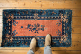 Apricot field, indigo floral motifs, and border bouquets on an antique Chinese Peking runner.