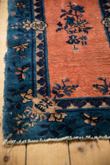Corner of antique Peking runner, apricot field, indigo floral border with light tatter.