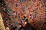 Vintage hand-knotted Lilihan carpet with blush rose field, blue floral vinery, and distinct navy border.