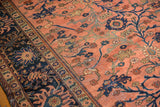 Curvilinear blue vinery and floral palmettes on blush Lilihan field, with wear and navy border.