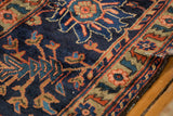 Vintage Lilihan carpet's intricate border with blush rose, sky blue, and gold floral patterns.