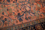 Close-up of blush dusty rose Lilihan carpet field with sprawling navy floral vinery and palmettes.