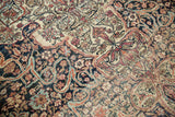 Low pile texture and visible knot heads of an antique Persian Kermanshah with intricate arabesques.
