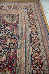 Elaborate borders of an antique Kermanshah showing low pile and intricate navy and cochineal red patterns.