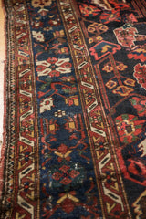 Vintage Baktiari carpet showing mostly even wear, faint foundation, and intricate floral patterns.