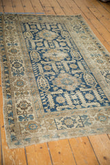 Intricate hand-knotted Caucasian Shirvan rug detail, featuring oversized geometric navy and ivory patterns.