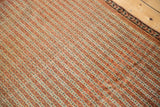 Close view of an antique Senneh rug's parallel lines, seed motifs, and fine, low-pile texture.