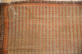 Corner of the antique Senneh rug showing wear to the knot heads and an area of visible foundation.