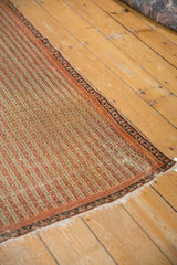The secured edge and striped seed motif on the corner of an antique Persian Senneh collector rug.