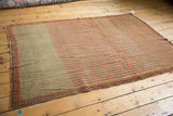 Circa 1880s Persian Senneh rug showing its striped seed design and secure perimeter border.