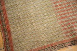 Evenly worn pile of an antique Senneh rug showing detailed seed motifs in terra cotta and charcoal.