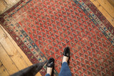 Antique Caucasian runner's madder red field with repeating boteh pattern and foundation wear.