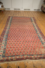 Antique Caucasian rug detail: madder red boteh, blue border, intact selvage, wear.