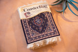 Packaged Midnight Persian CoasterRug set, featuring intricate Herati pattern and ivory fringe.