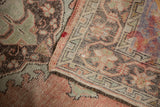 Distressed vintage Oushak rug detail: worn pile texture, exposed knot heads, intact selvage.