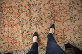 Distressed apricot blush and sea foam green scrolling floral Oushak rug with even wear.