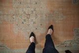 Textured low pile of vintage Turkish Oushak rug in apricot, ivory, and pale blue.