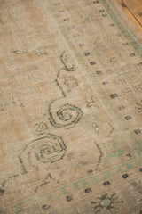 Distressed vintage Oushak pile showing even wear, foundation, and faded green blue motifs.