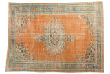 Vintage distressed Oushak carpet: apricot orange, roundel medallion, faded green and blue florals.