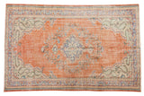 Vintage Distressed Oushak carpet, orange-red field, central floral medallion, pale blue, ivory, green accents. 5'7