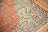 Designer-aligned distressed Oushak rug texture, worn brick red field, ivory floral vinery.