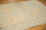 Distressed vintage Oushak runner texture with faded sand, pale sea foam green, and geometric medallion.
